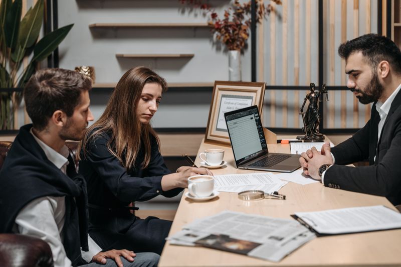 Legal team reviewing case documents together at a law office table